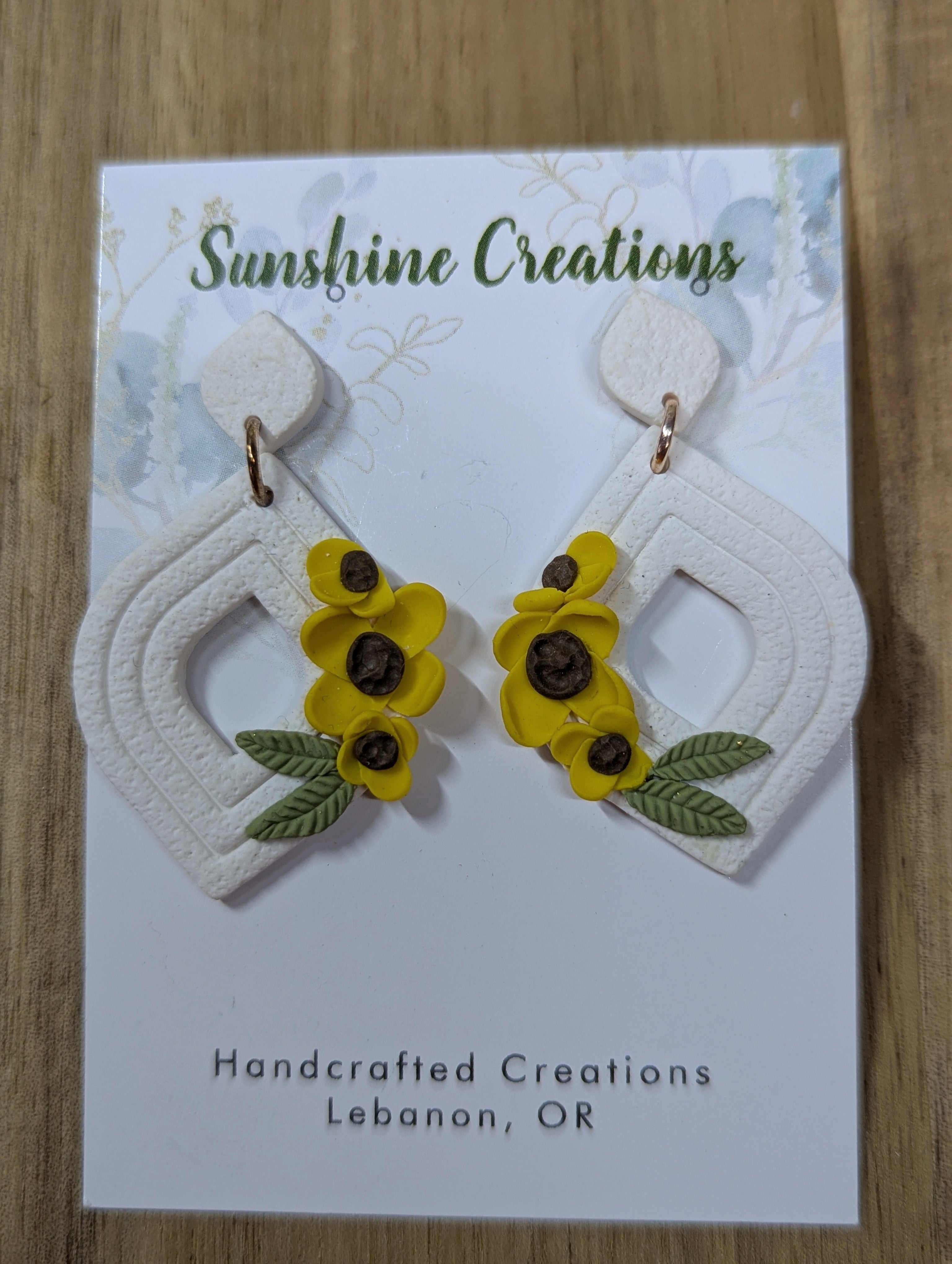 White tear drop earrings with yellow flowers