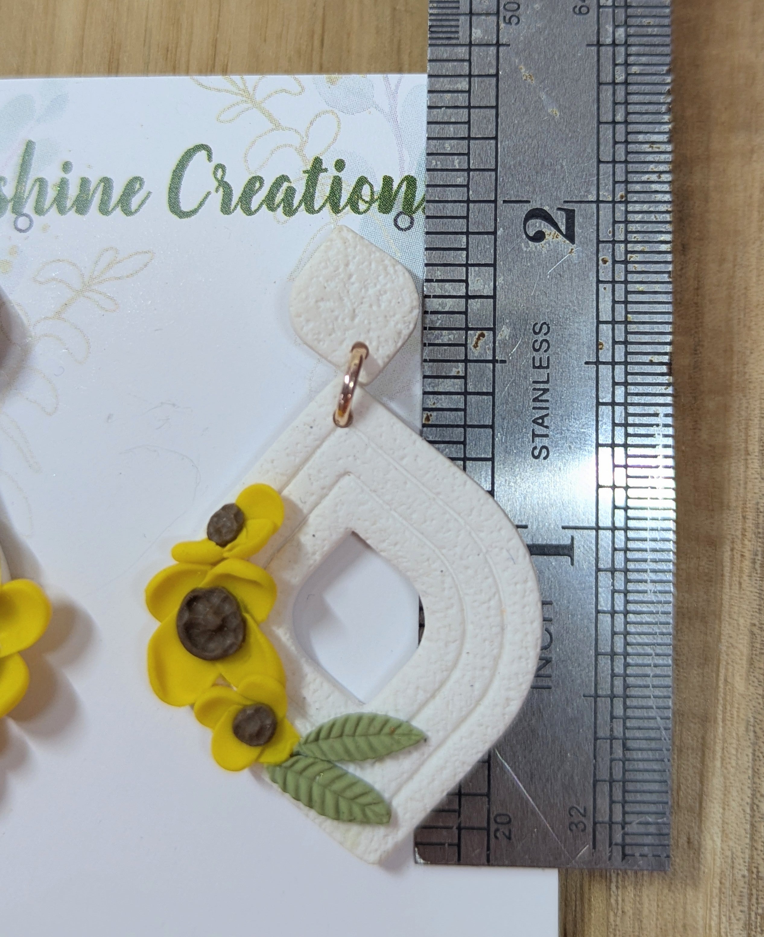 White tear drop earrings with yellow flowers
